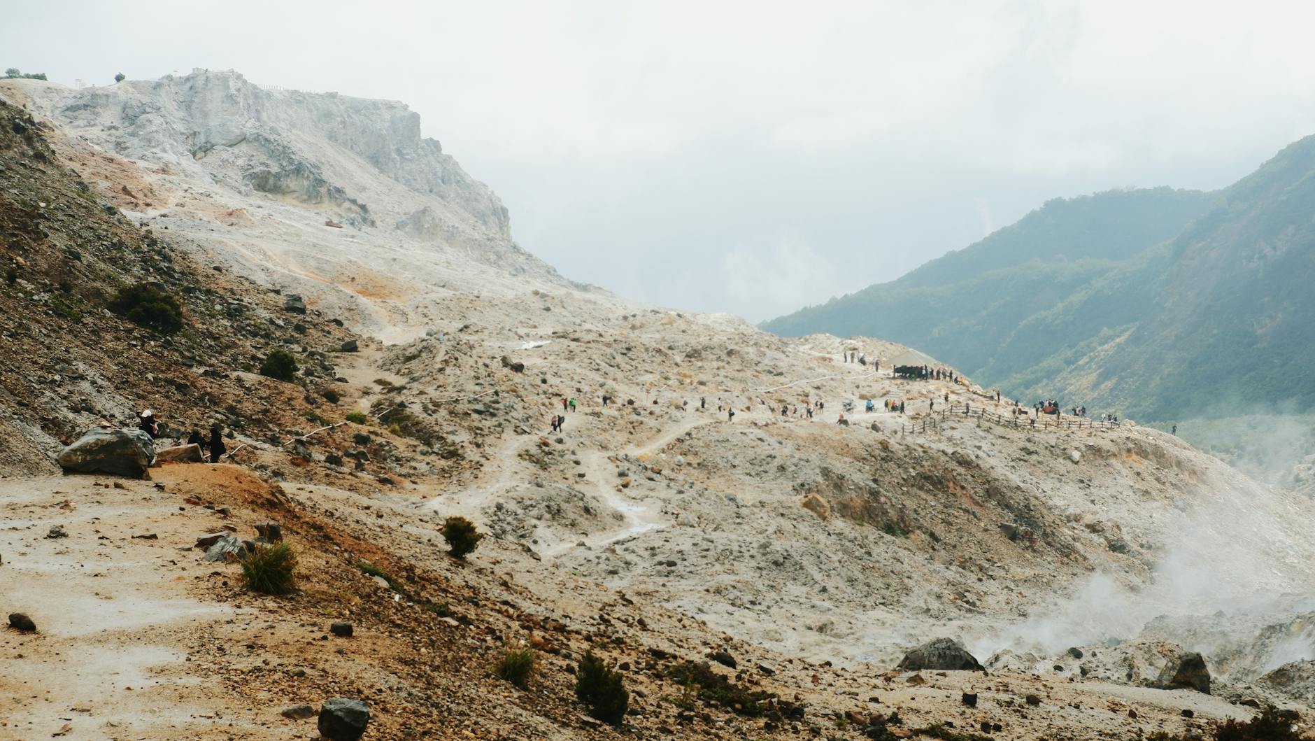 Trekkingowcy idą skalistym szlakiem na wulkanie Mount Papandayan